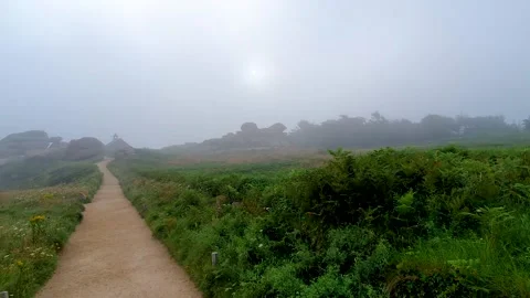 Pathway through the mist with a chapel in the background on the coast of plo Stock Footage 161325692