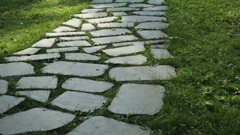 A pathway is visible as it winds through grass and garden areas made of stone 動画素材 344527879