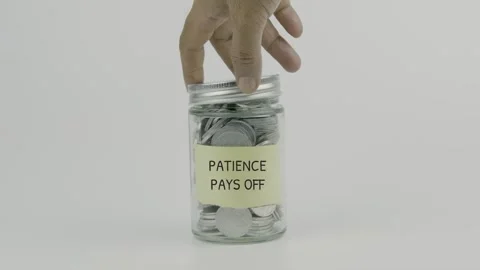 Patience Pays Off text or word on yellow sticky notes attached to a coin jar Stock Footage 307162654