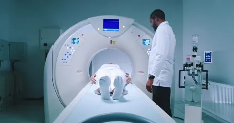 Patient after tomography procedure. Multicultural doctor finishes magnetic Stock Footage 243609157