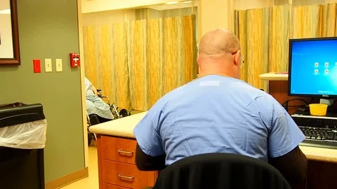 Patient being brought up to nurses station Stock Footage 70687086