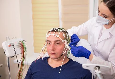 Patient brain testing using encephalography at medical center Stock Photos