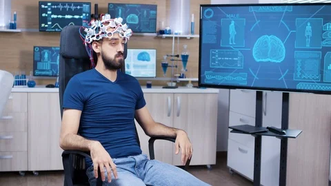 Patient with brainwaves scanning headset closing his eyes Video stock 119654019
