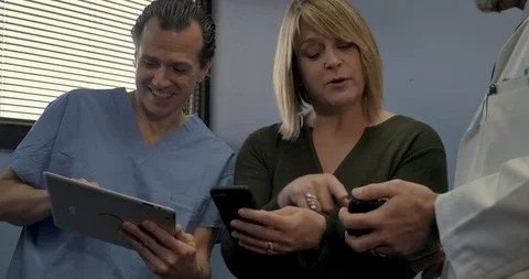 Patient comparing health data on her phone with her healthcare providers Stock Footage 102345571