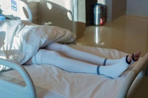 Patient in Compression Stockings Lying on Bed Stock Photos