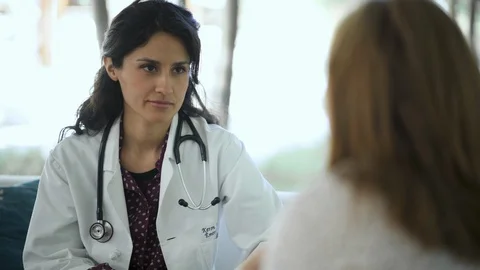 Patient discussing her problems with physician in a clinic Video stock 105607481