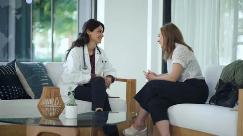 Patient discussing her problems with physician in a clinic Stock Footage 105607503