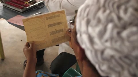 Patient doing Eye test with eye chart in  rural clinic Vídeos de archivo 165456078