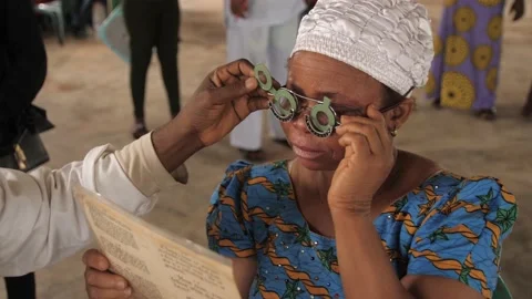 Patient doing Eye test with eye chart in  rural clinic Stockbeeldmateriaal 165456144