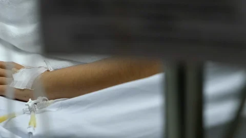 Patient hand with saline solution in Intravenous Drip Dropper. Stock Footage 101801053