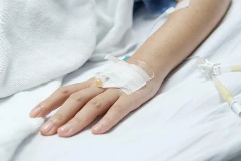 Patient hand with saline solution in Intravenous Drip Dropper. 스톡 사진