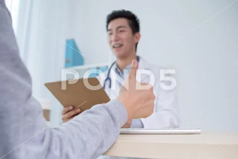 Patient Having Consultation With Doctor In Office Stock Photos