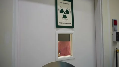 Patient inside radiology room seen through vision panel during dental Stock Footage 280189885