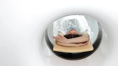 Patient inside tomography scanner during medical imaging procedure. 스톡 동영상 347776115