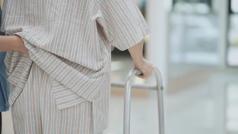 Patient learning to use walker with physical therapist	 Stock Footage 130130552