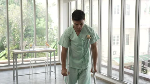 Patient Leg pain try to practicing walking with crutches assisted in hospital Stock Footage 278358011