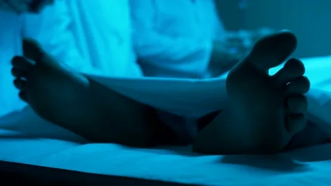 The patient lies on the operating table among the doctors. Close-up of the legs. Stock Footage 143631553