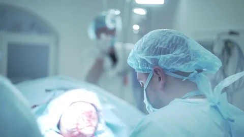 The patient lies on the operating table. the surgeon is sitting next to and disc Video stock 70793610
