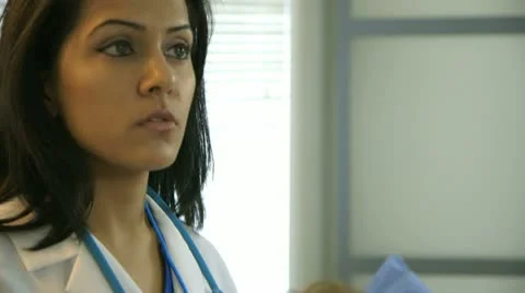 Patient listening to her doctors talking about the findings Stock Footage