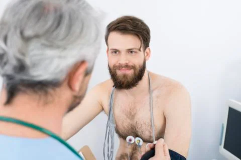 Patient Looking At Doctor While Undergoing Electrotherapy 写真素材