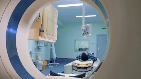 Patient lying on the CT or MRI scanner. Patient's scanning procedure is starting Stock Footage 90898568