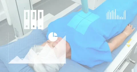 Patient lying on table, tech placing scanner on pad, showing medical charts and Stock Footage 330916988
