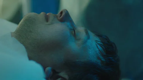 Patient lying unconscious on the bed Stock Footage 283146741