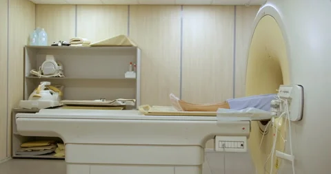 Patient in MRI Device. Almost Doesn't Move. Research in Progress. Twitches Legs Stock Footage 136738413