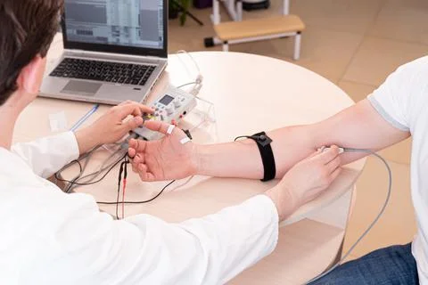 Patient nerves testing using electromyography at medical center Stock Photos