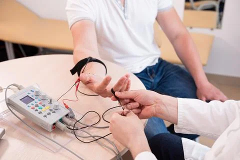 Patient nerves testing using electromyography at medical center Stock Photos