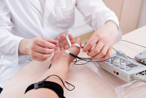 Patient nerves testing using electromyography at medical center Stock Photos