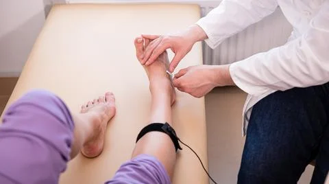 Patient nerves testing using electromyography at medical center Stock Photos