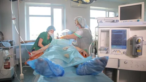 Patient on the operating table. Nurses prepare patient for the operation. Video stock 99221236