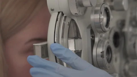  patient with ophthalmic microscope or Phoropter. Use, adjust different lenses. Stock Footage 153281135