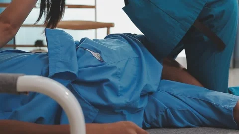 Patient at the physiotherapy doing physical exercises with his therapist Stock Footage 276562452