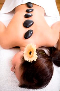 Patient in a physiotherapy practice getting a hot stone massage Stock Photos