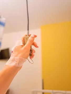 Patient press the help button for nurse calling one the bed in the hospital. Stock Photos