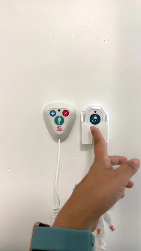 Patient presses the emergency buzzer to call for the nurse Stock Footage 297865129