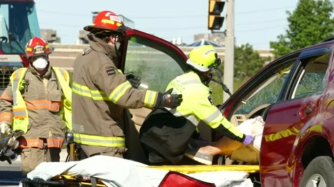 Patient pulled out of driver seat after collision by paramedic with yellow Stock Footage 133973529