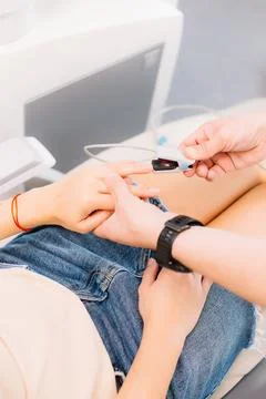Patient with pulse and oxygen sensor at dentist's appointment. Anesthesiology Stock Photos