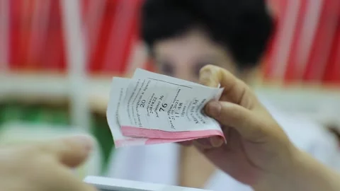 The patient takes a ticket with a queue number Stock Footage 245414812