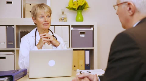 Patient talking to doctor in office Stock Footage 34372425