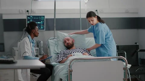 Patient talking with medical doctors while sitting in bed during disease Stock Footage 153758965