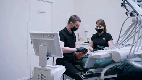 The patient is undergoing surgery in the dentist Stock Footage 112144770