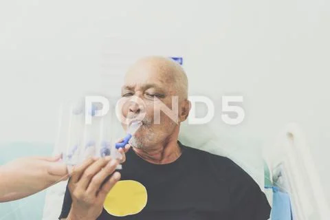 Patient use Incentive Spirometer in hospital Stock Photos