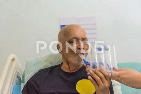 Patient use Incentive Spirometer in hospital Stock Photos