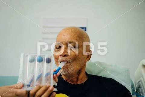 Patient use Incentive Spirometer in hospital Stock Photos