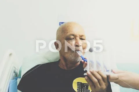Patient use Incentive Spirometer in hospital Stock Photos