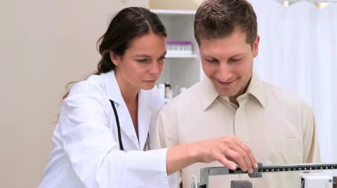 Patient using weighing scales Stock Footage 10815152