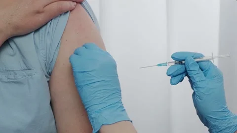 The patient is vaccinated by a nurse. Close-up of the introduction Stock Footage 148174435